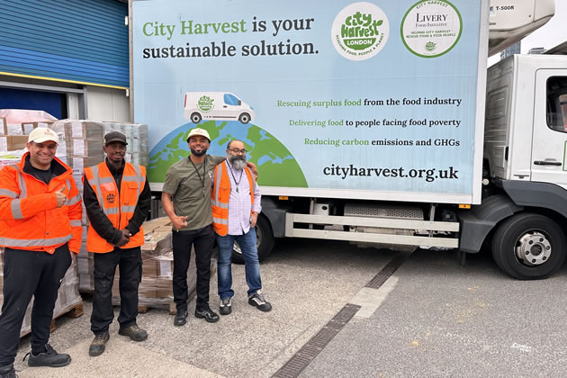 A Pasta Evangelists staff member loading food donation boxes with the City Harvest team