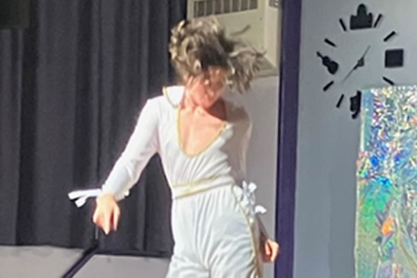 Pharoah in this production is all in white with scarlet-trimmed flares