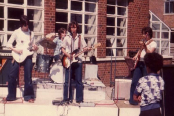 The band members performing during their school days