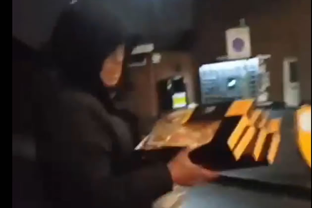 The alleged thief with multiple boxes of pizza