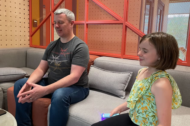 Daisy trying out the Stix Mindfulness device with her father 