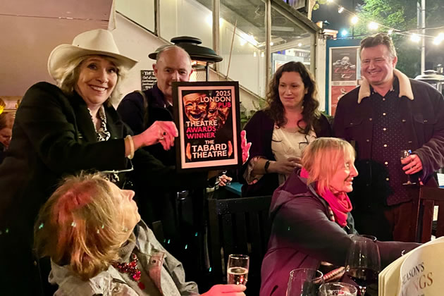 Phyllis Logan (left) displaying the framed plaque to be given to Sarah and Simon Reilly